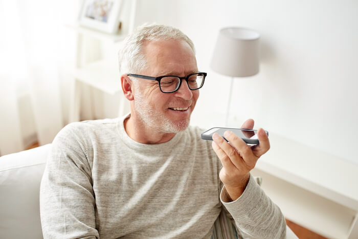 Older man wearing glasses and talking on phone