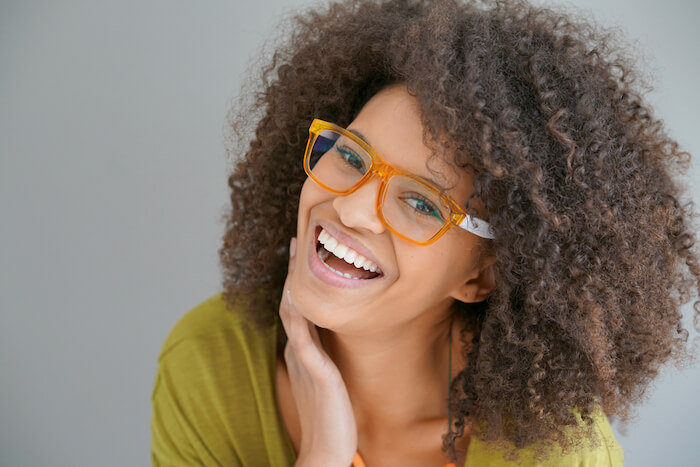 Young woman wearing trendy orange glasses