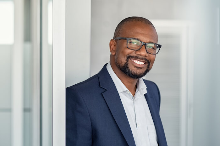 Middle-aged man wearing glasses and smiling